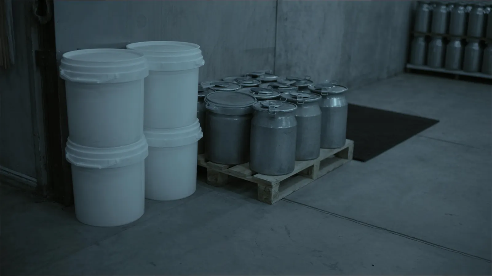 Plastic and metal pails stacked on a pallet